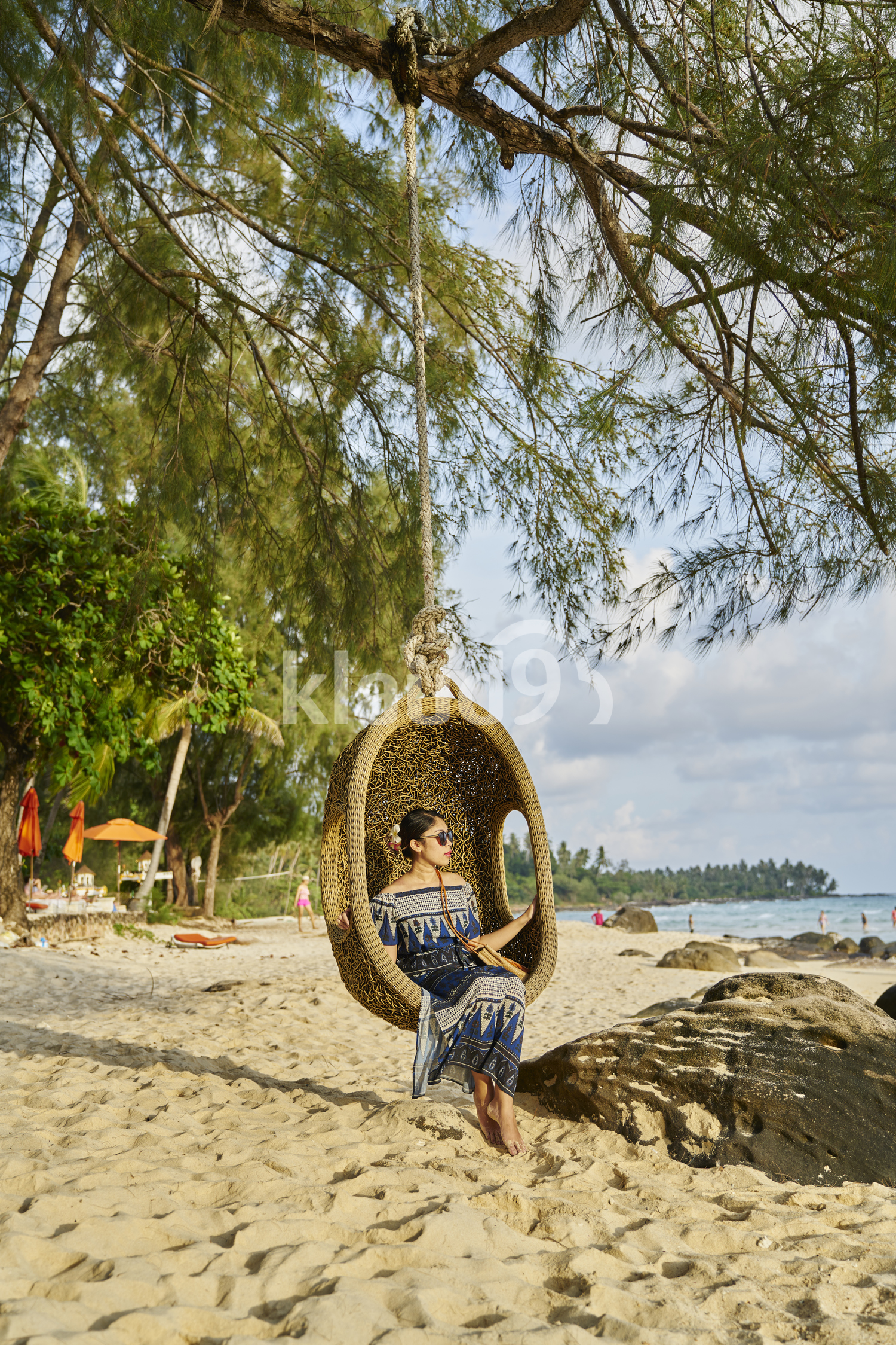 Young woman sitting by the beach in Koh Kood, Thailand 
