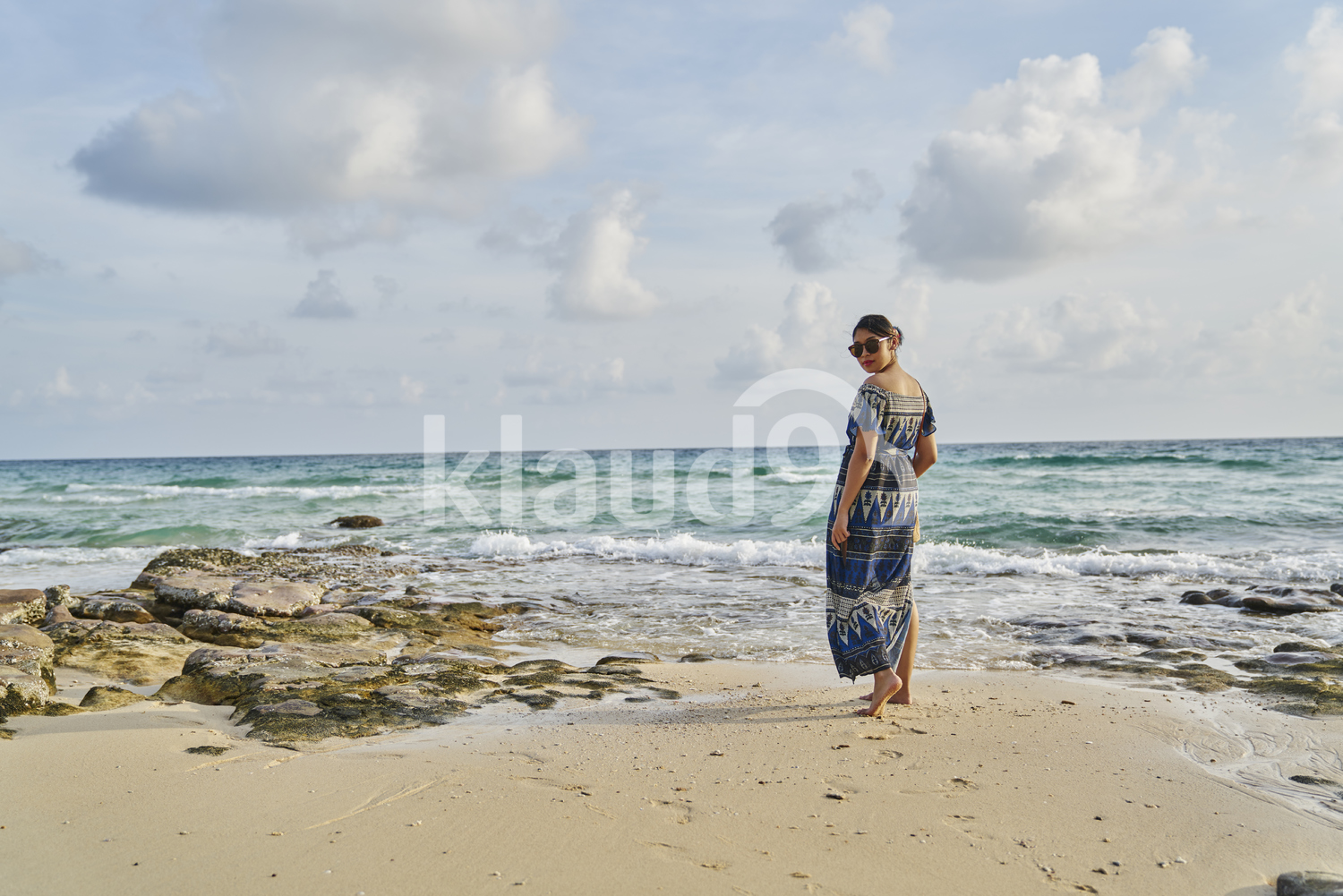 Young woman walking by the beach in Koh Kood, Thailand