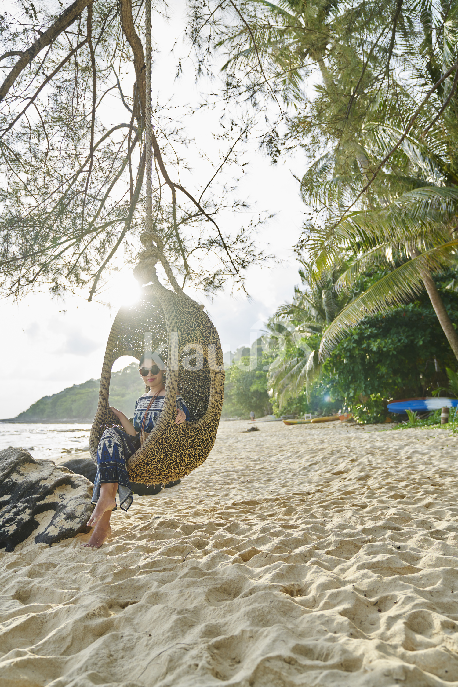 Young woman sitting by the beach in Koh Kood, Thailand