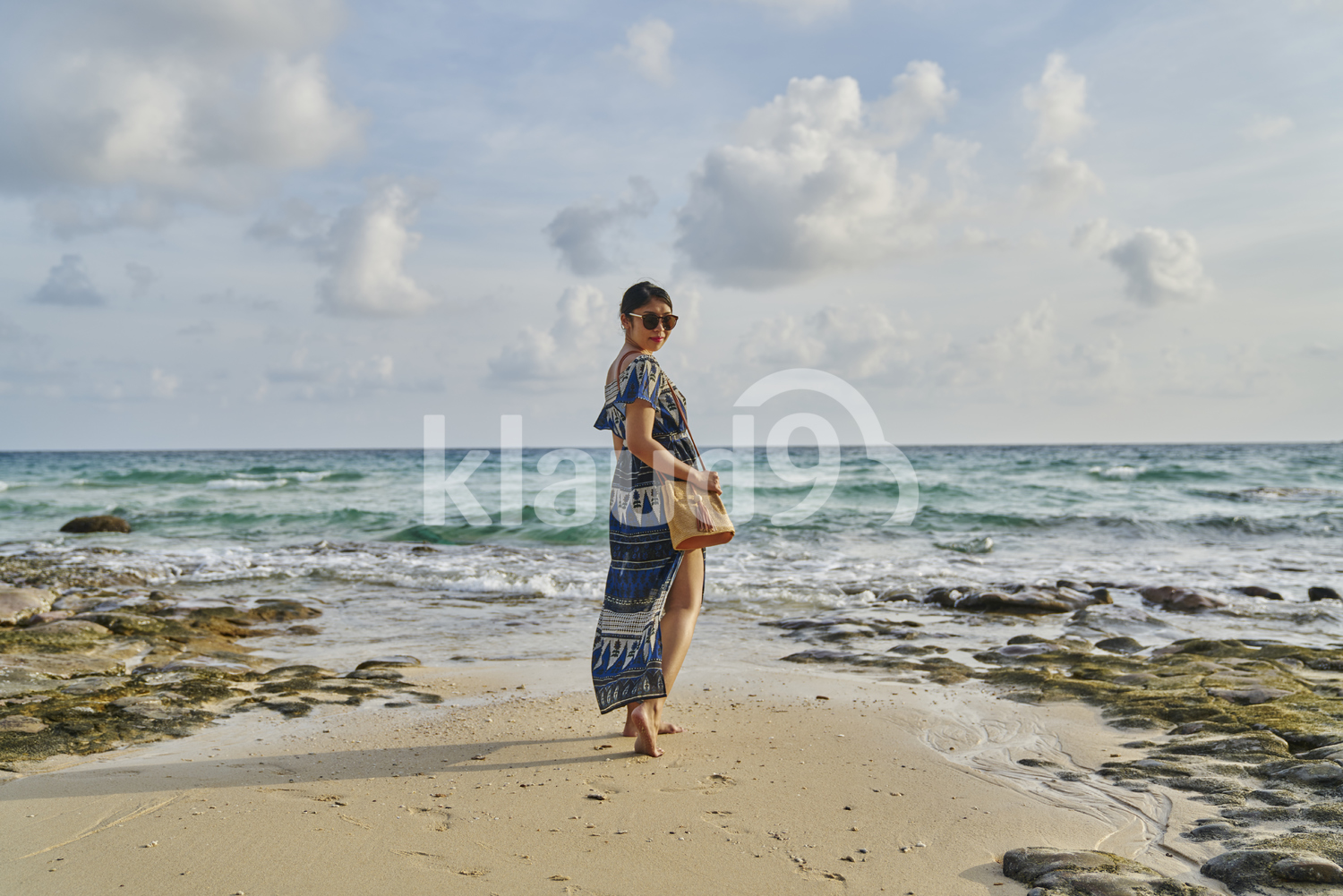 Young woman walking slowly by the beach in Koh Kood, Thailand