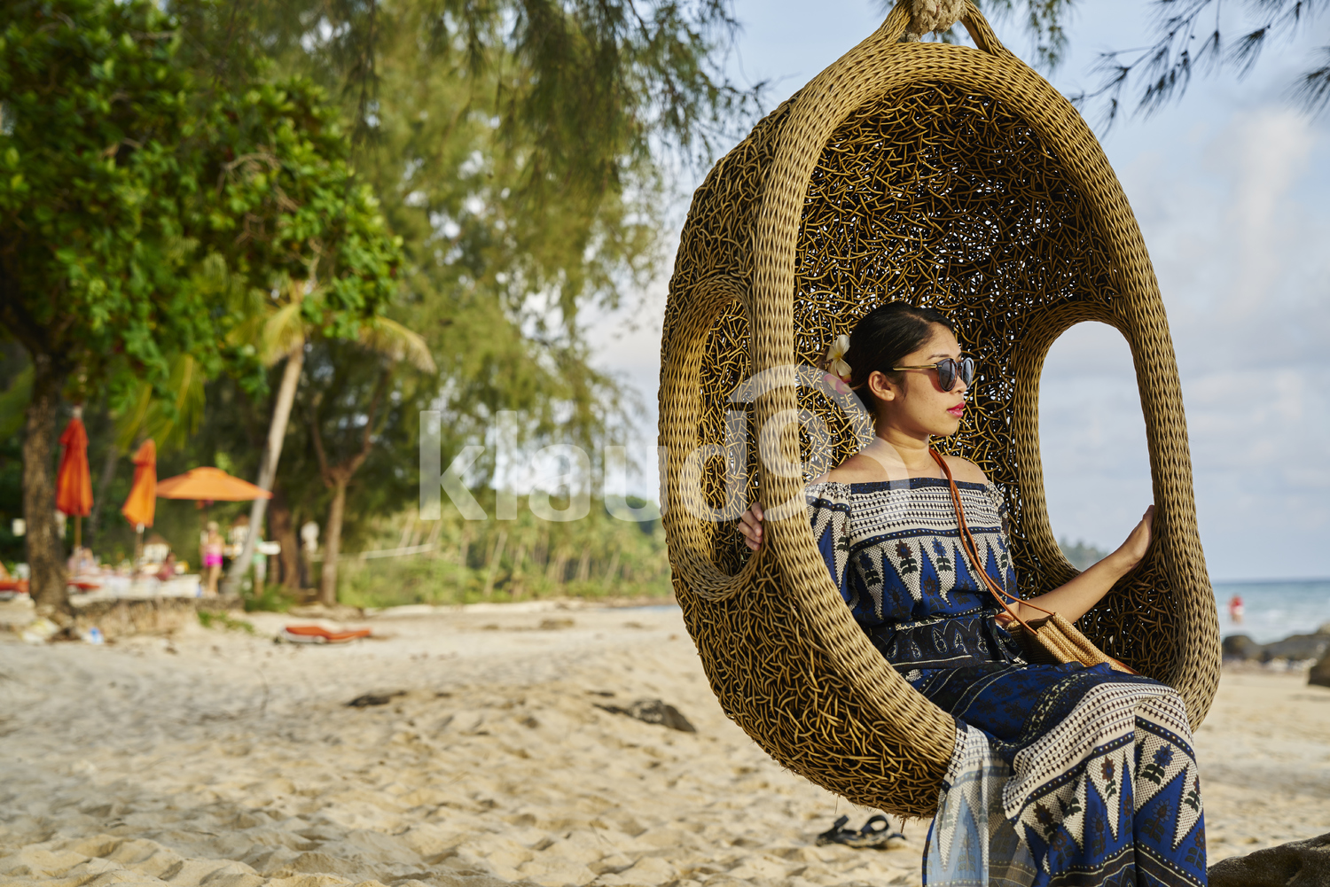 Young woman sitting by the beach in Koh Kood, Thailand 