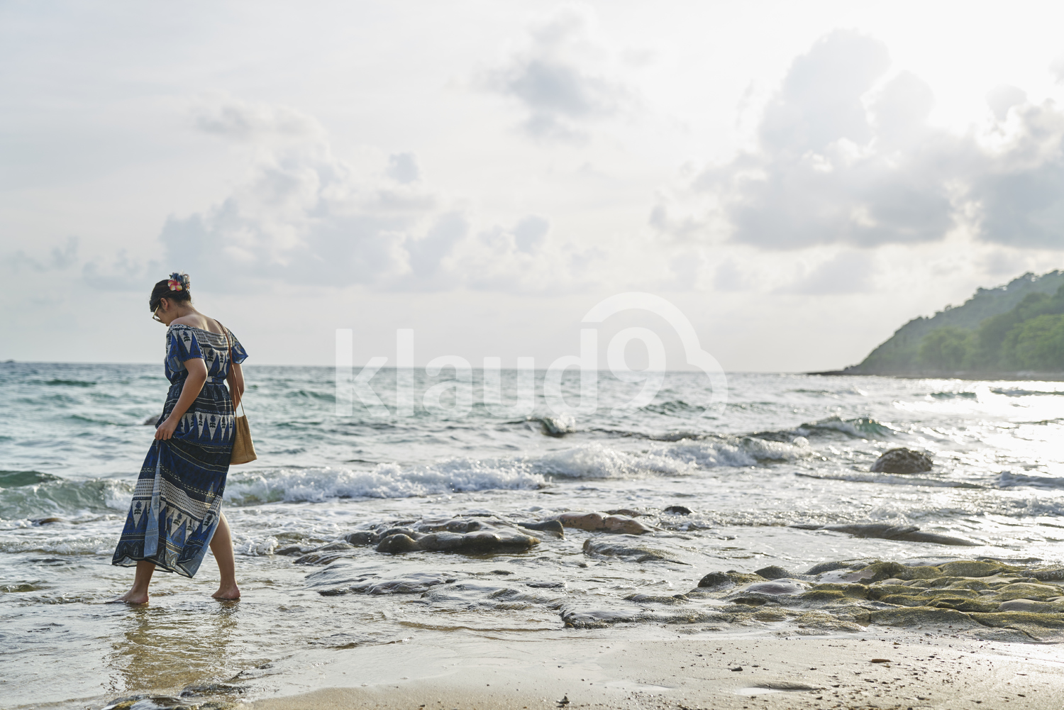 Young woman walking by the beach in Koh Kood, Thailand