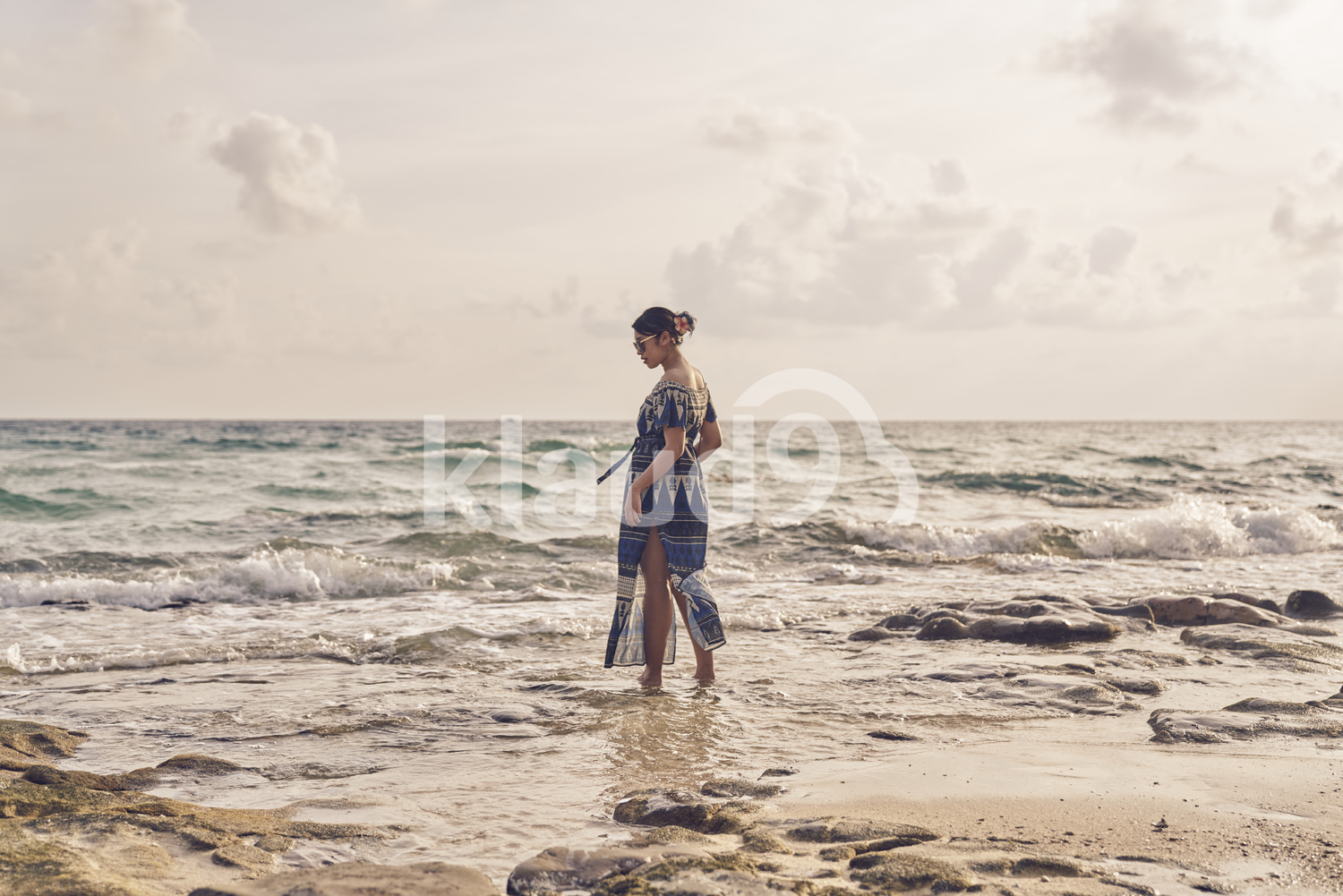 Back view of Young woman walking by the beach in Koh Kood, Thailand