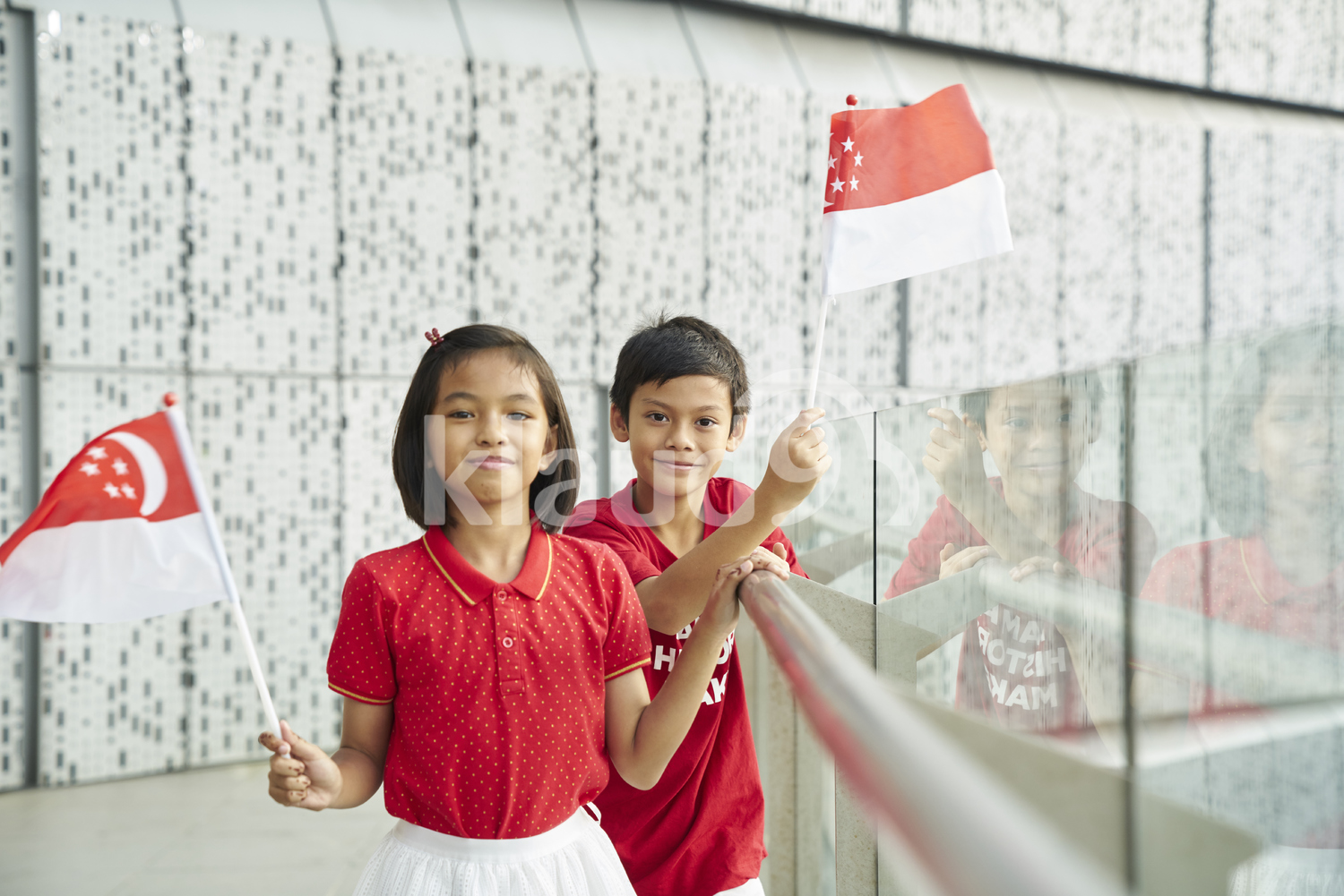 Cute siblings celebrating Singapore's National Day