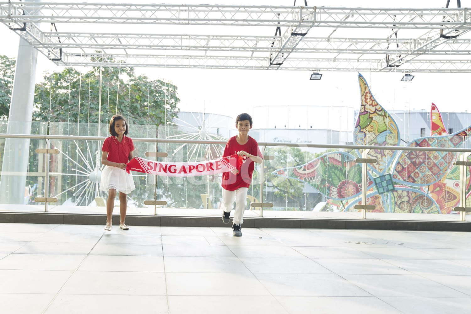 Two siblings celebrating Singapore's National Day
