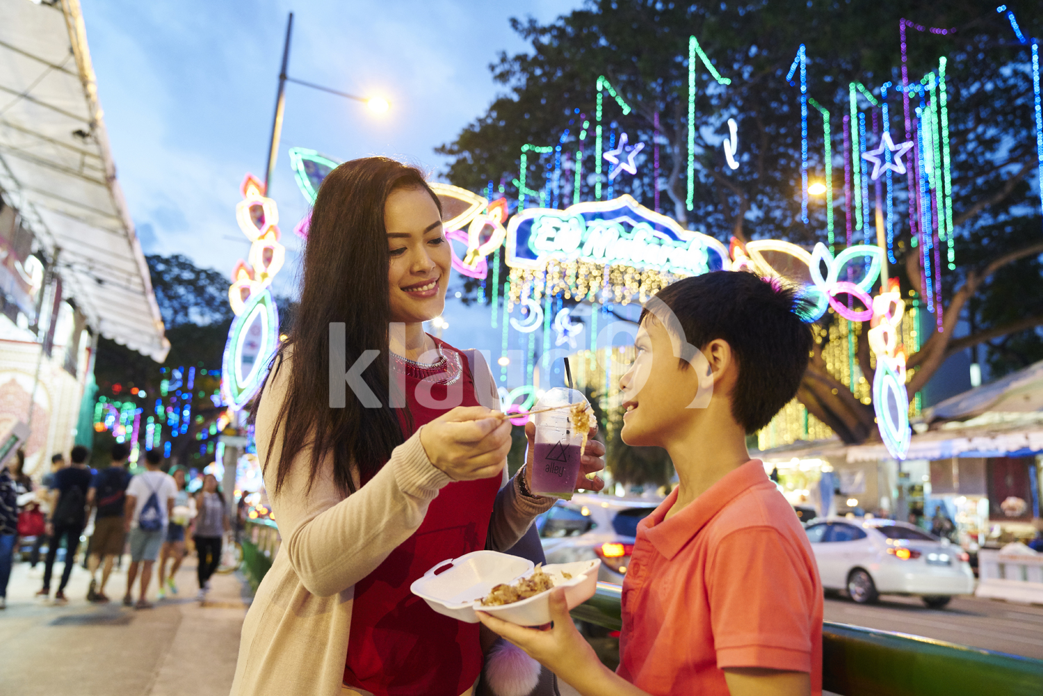 Mother breaking fast with her son at Geylang Hari Raya Bazaar, Singapore