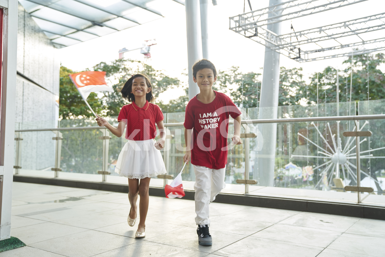 Playful siblings celebrating Singapore's National Day