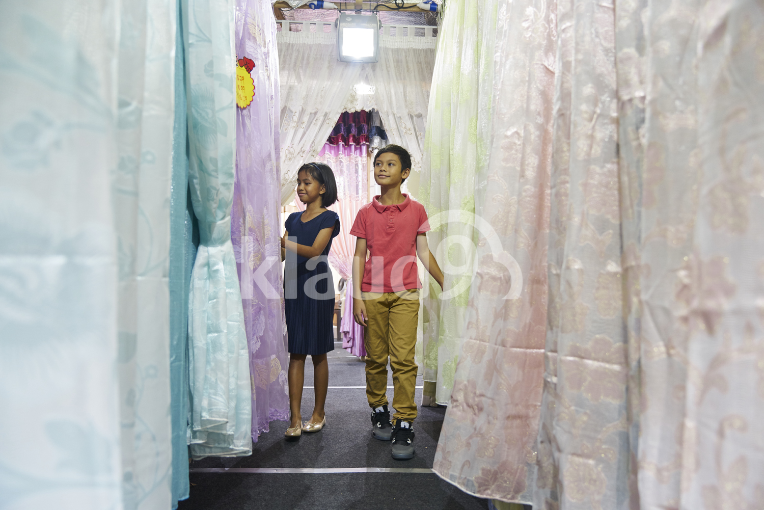 Siblings shopping for curtains during Hari Raya Bazaar at Geylang, Singapore