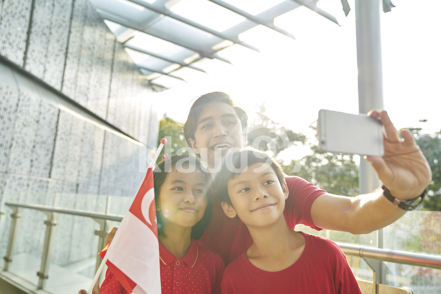 Cheerful family celebrating Singapore's National Day