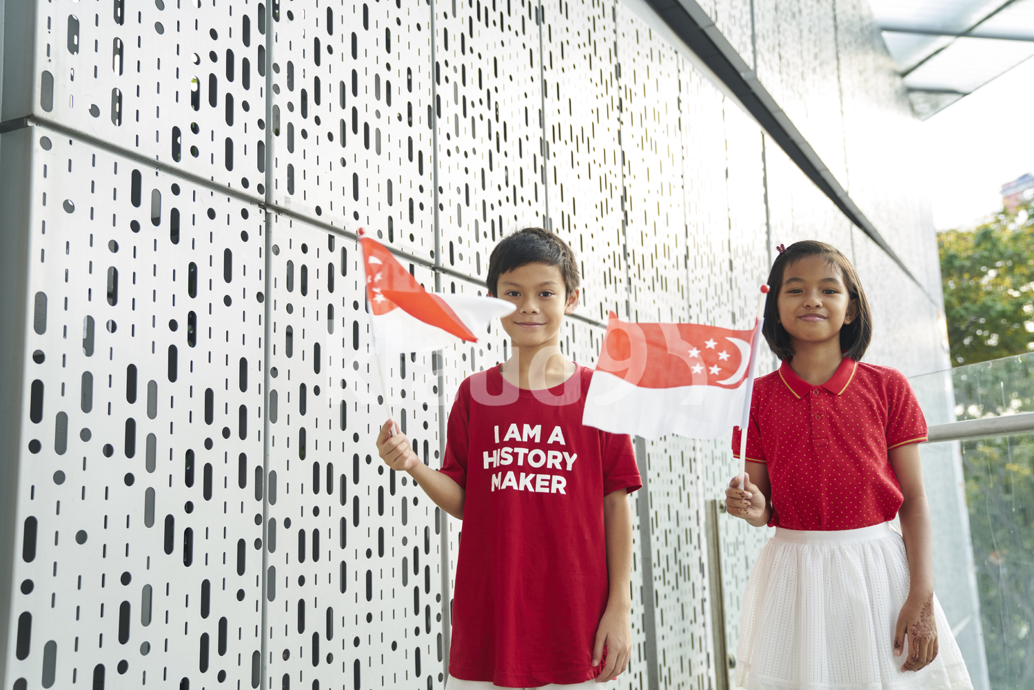 Young siblings celebrating Singapore's National Day