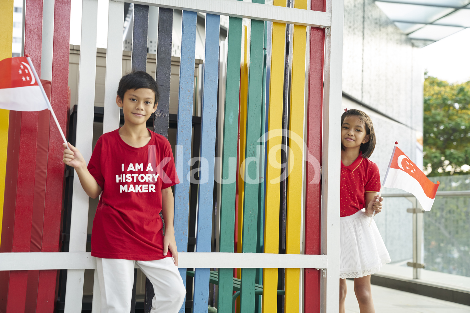 Cheerful siblings celebrating Singapore's National Day