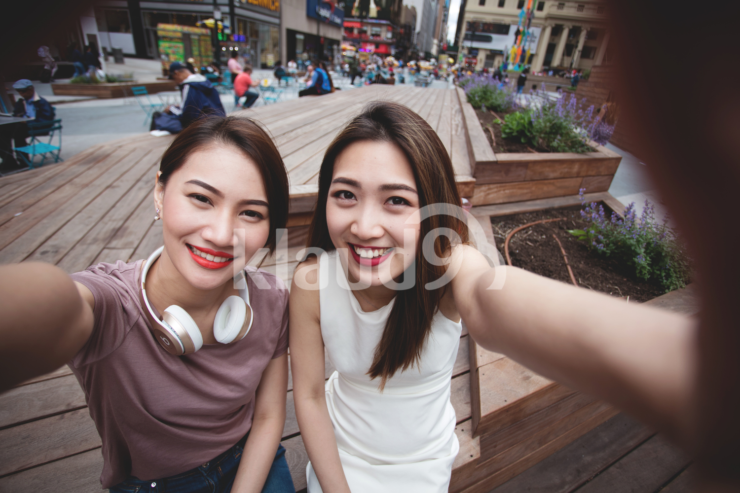 Women taking a selfie with Empire state build in the background. 