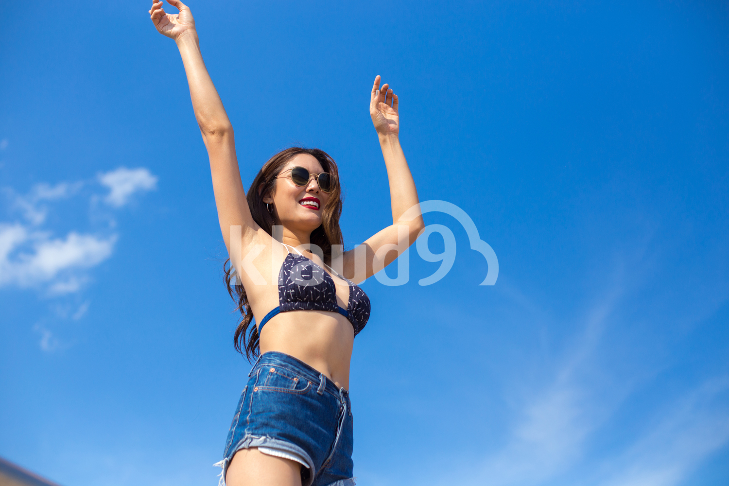 Smiling to the sun on the beach in summertime 