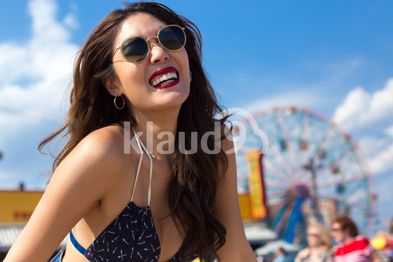 Smiling to the sun on the beach in summertime 