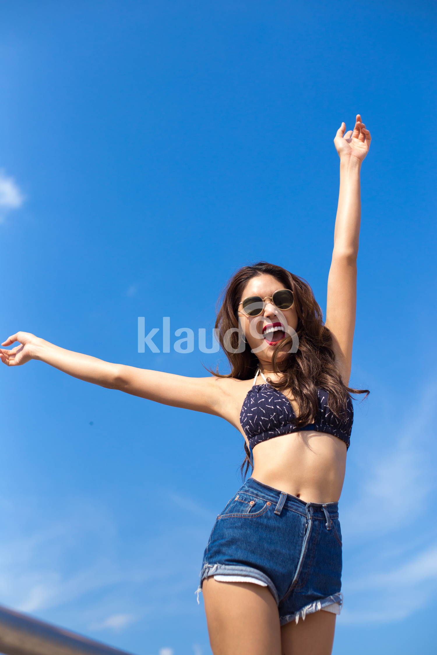 Smiling to the sun on the beach in summertime 