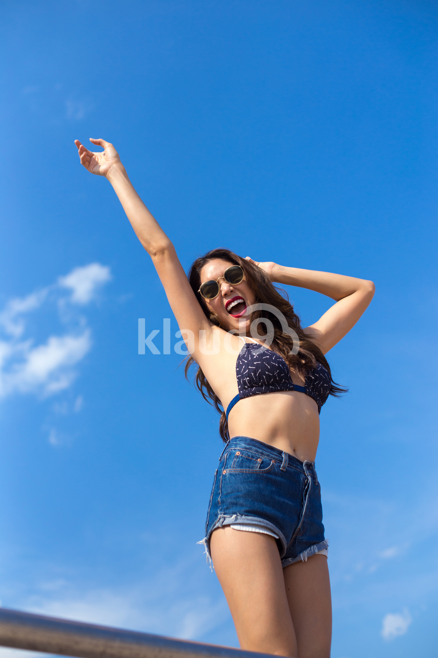 Smiling to the sun on the beach in summertime 