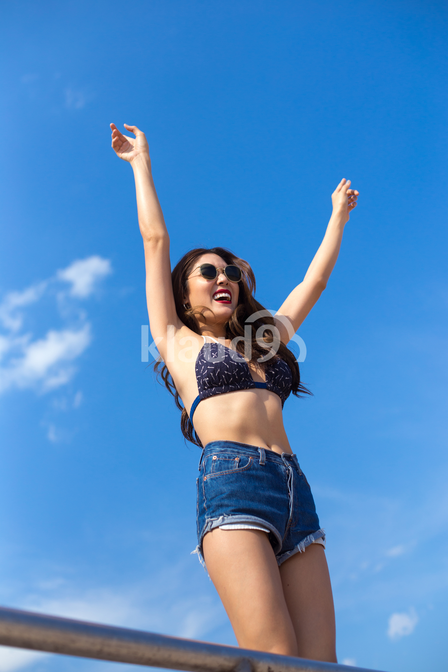 Smiling to the sun on the beach in summertime 
