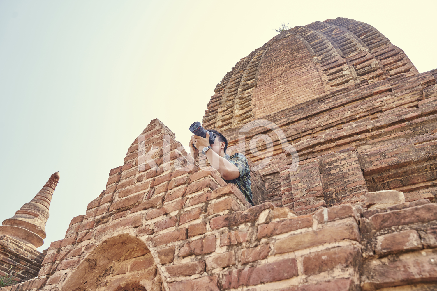Young Man Taking Photos Around Of The Ancient Temple, Pagoda, Bagan, Myanmar