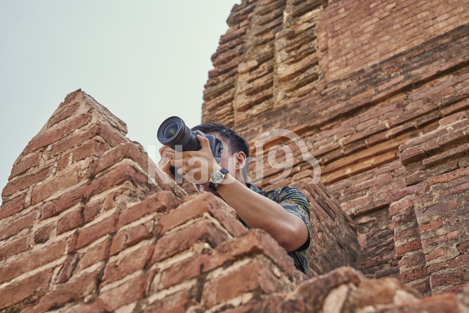Young Man Taking Photos Around Of The Ancient Temple, Pagoda, Bagan, Myanmar