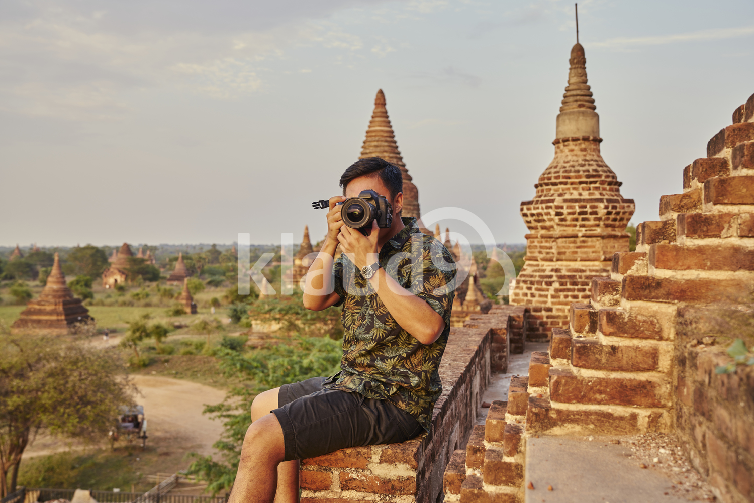 Young Man Taking Photos Around The Ancient Pyathadar Temple, Bagan, Myanmar