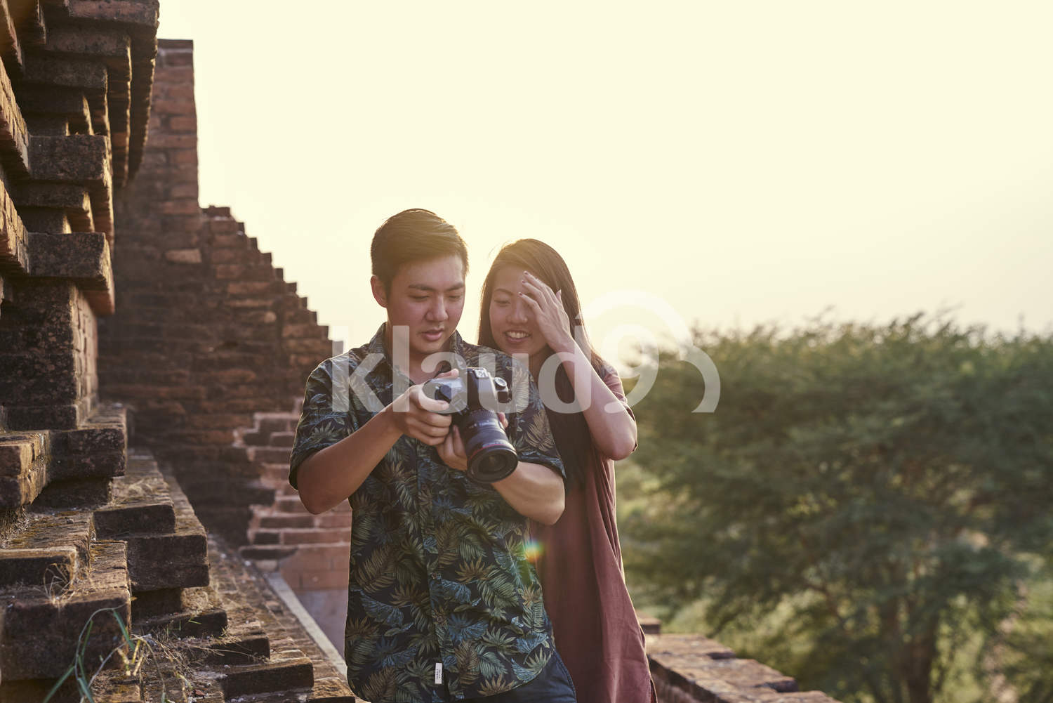 Young Couple Taking Photos Around The Ancient Pyathadar Temple, Bagan, Myanmar