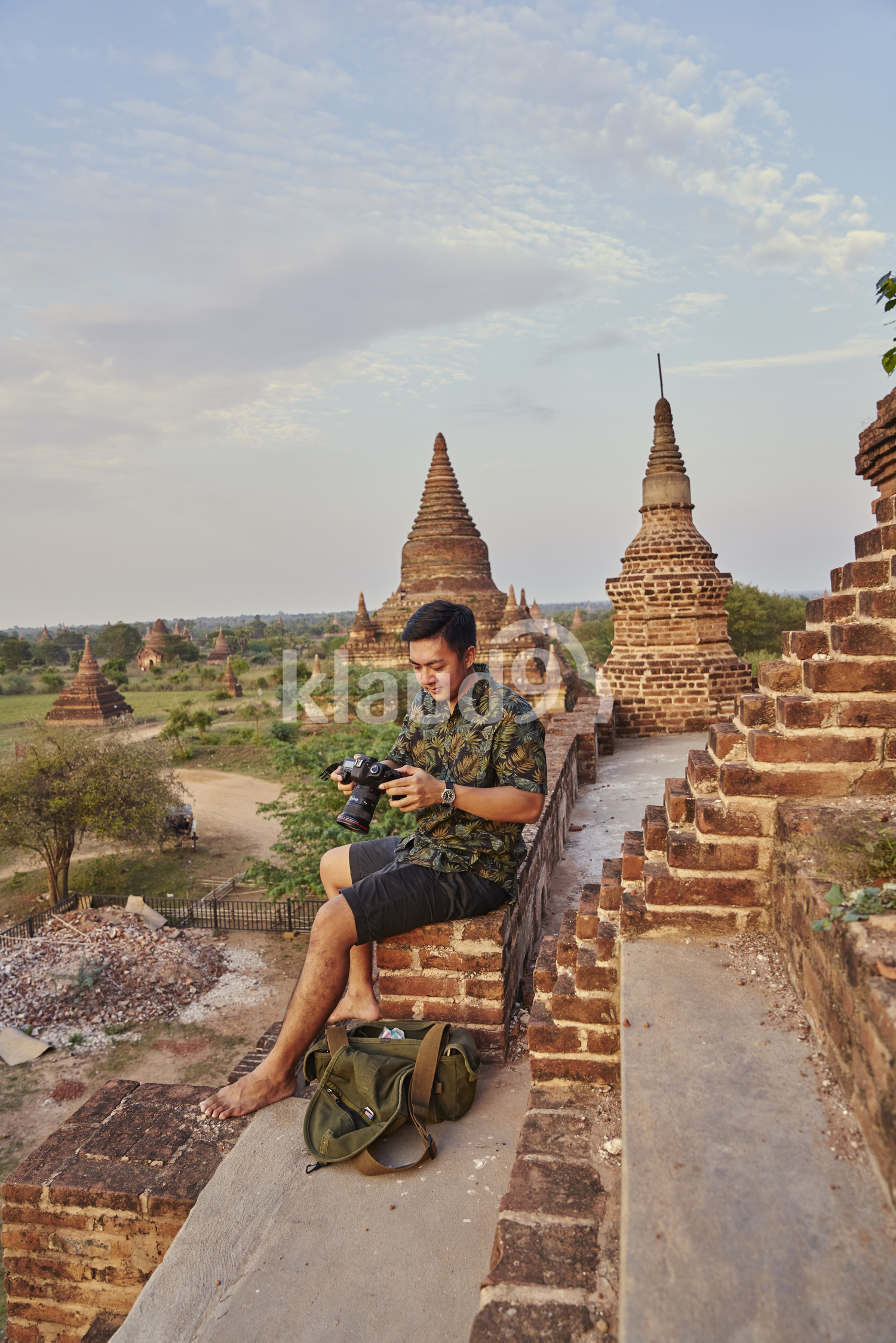 Young Man Taking Photos Around The Ancient Pyathadar Temple, Bagan, Myanmar