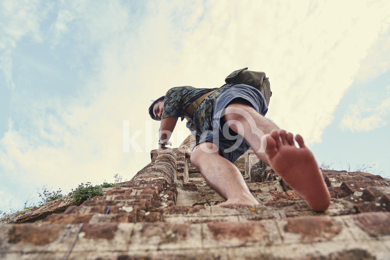 Young Man Climbing Down The Steps Of The Ancient Pyathadar Temple, Bagan, Myanmar