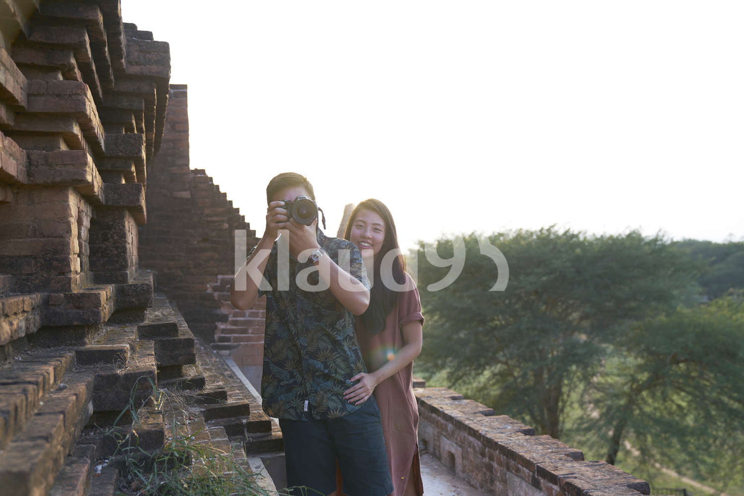 Young Couple Taking Photos Around The Ancient Pyathadar Temple, Bagan, Myanmar