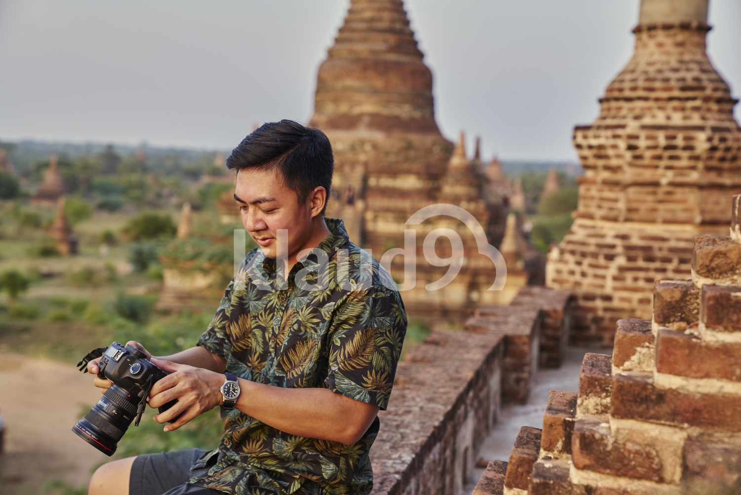Young Man Taking Photos Around The Ancient Pyathadar Temple, Bagan, Myanmar