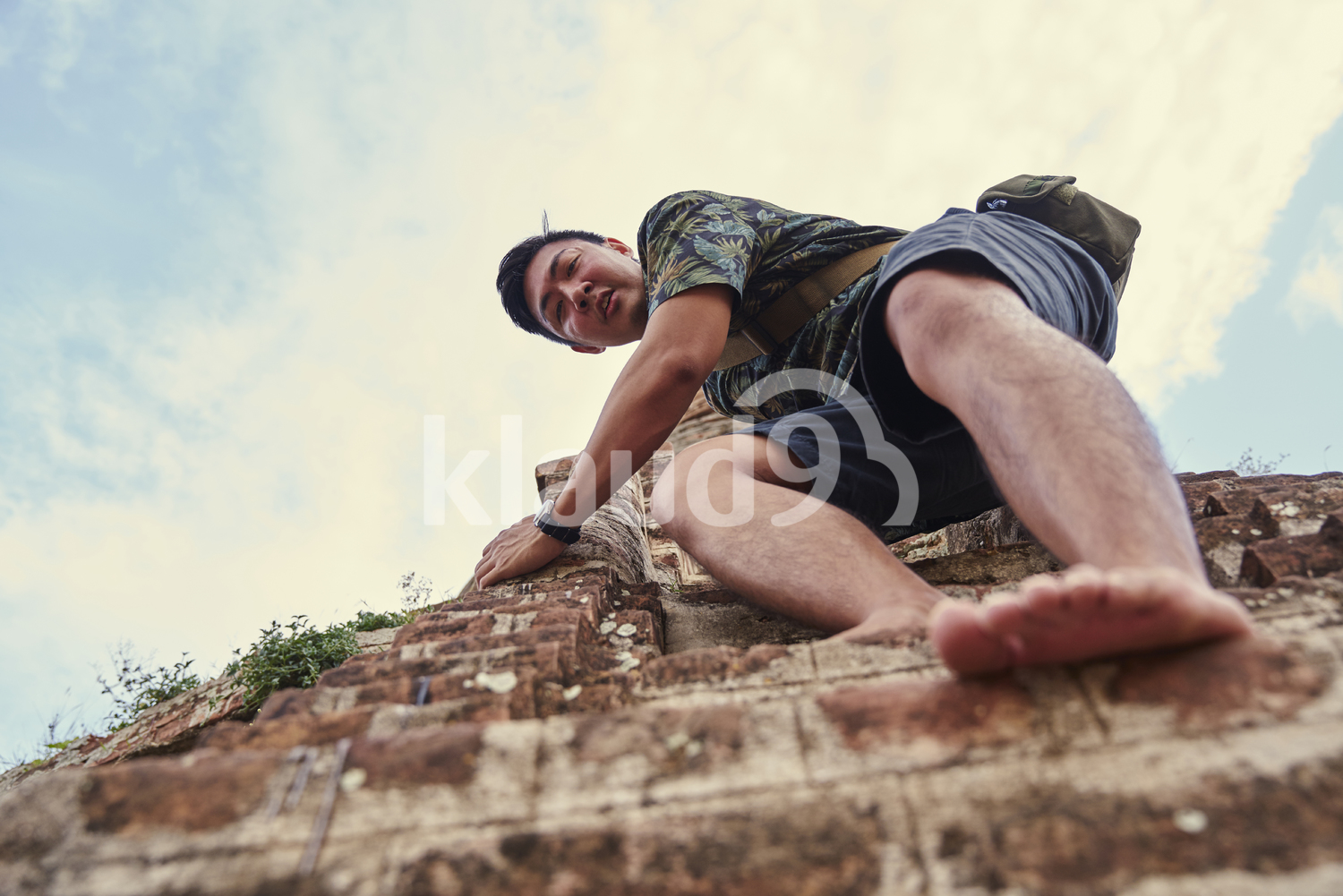 Young Man Climbing Down The Steps Of The Ancient Pyathadar Temple, Bagan, Myanmar