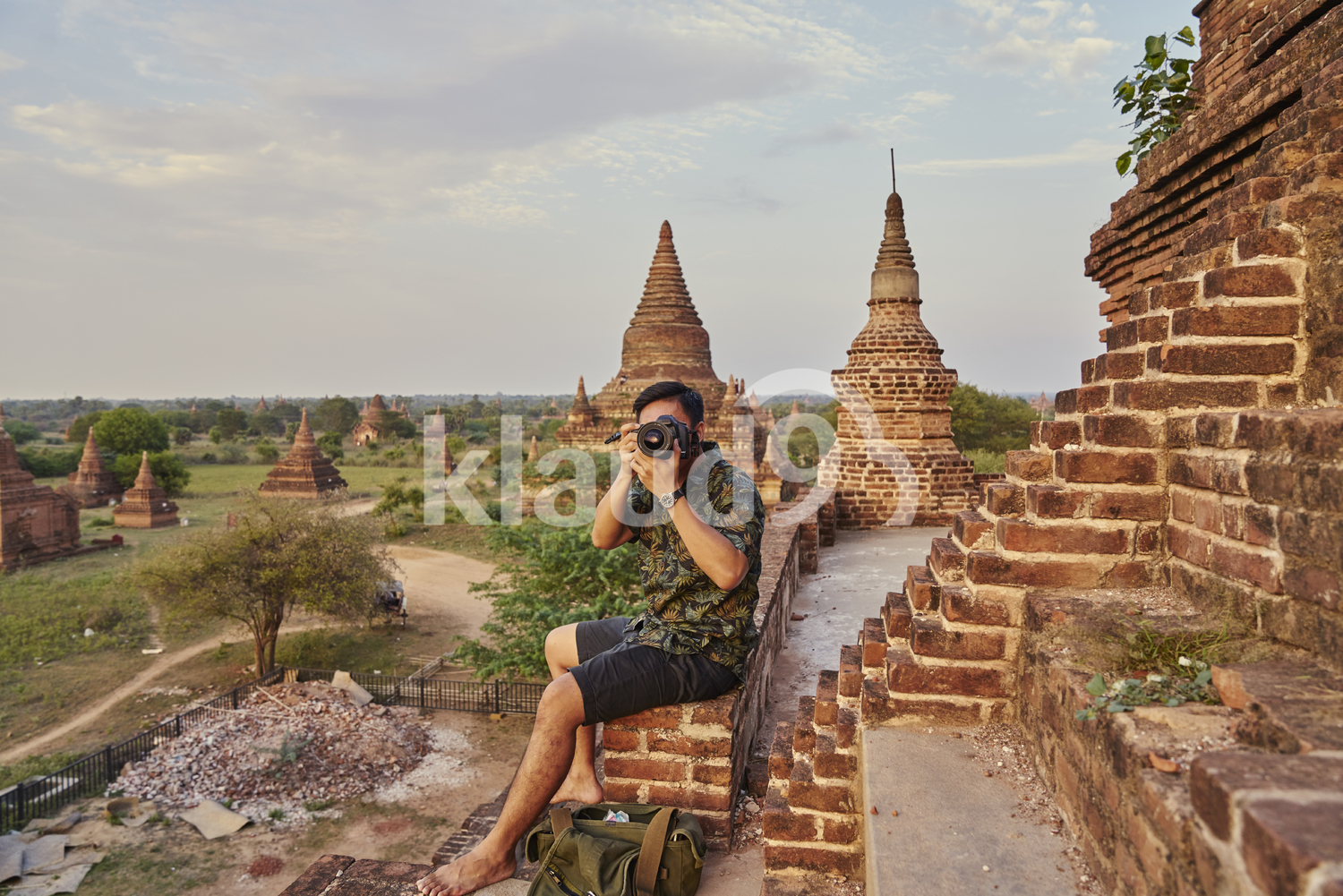 Young Man Taking Photos Around The Ancient Pyathadar Temple, Bagan, Myanmar