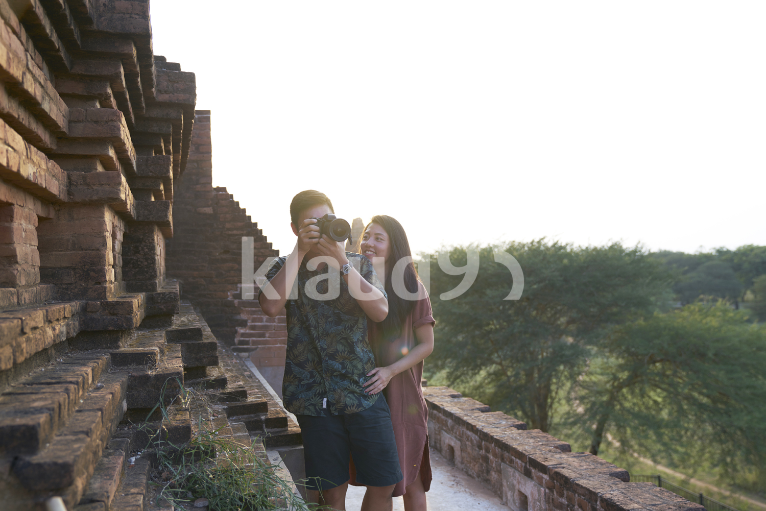 Young Couple Taking Photos Around The Ancient Pyathadar Temple, Bagan, Myanmar