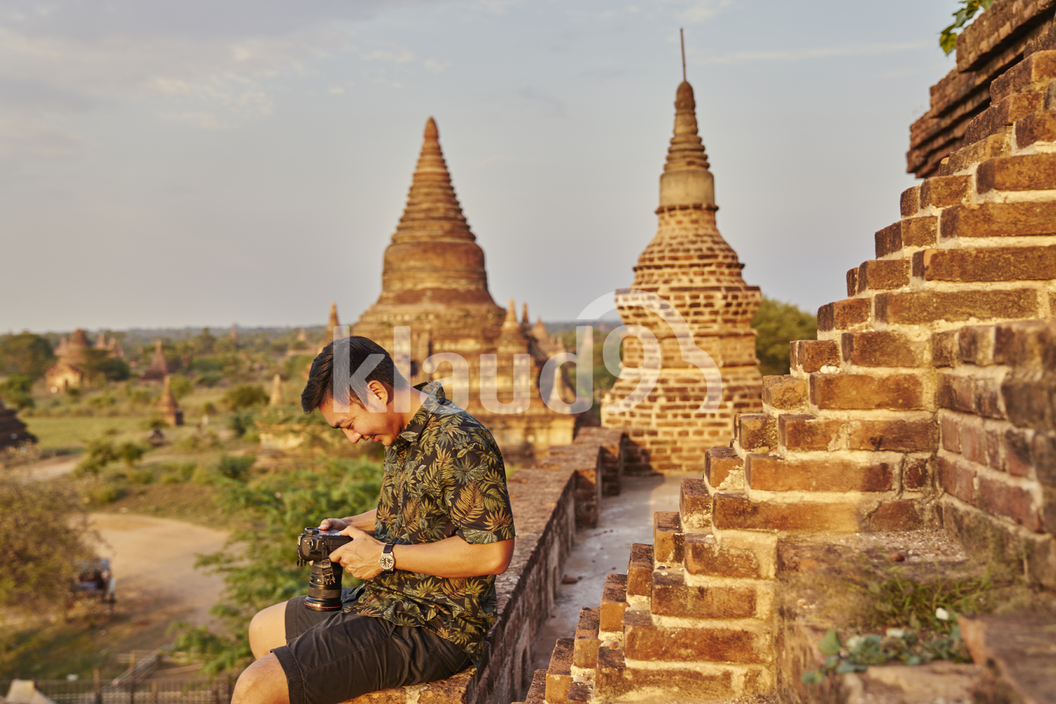 Young Man Taking Photos Around The Ancient Pyathadar Temple, Bagan, Myanmar
