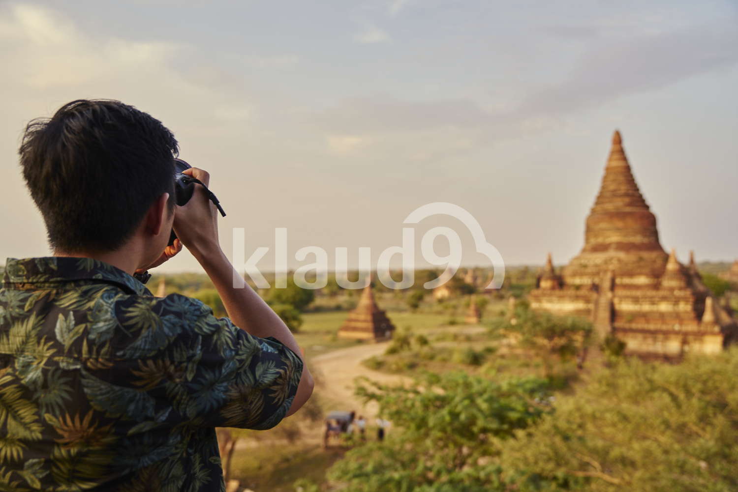 Young Man Taking Photos Around The Ancient Pyathadar Temple, Bagan, Myanmar