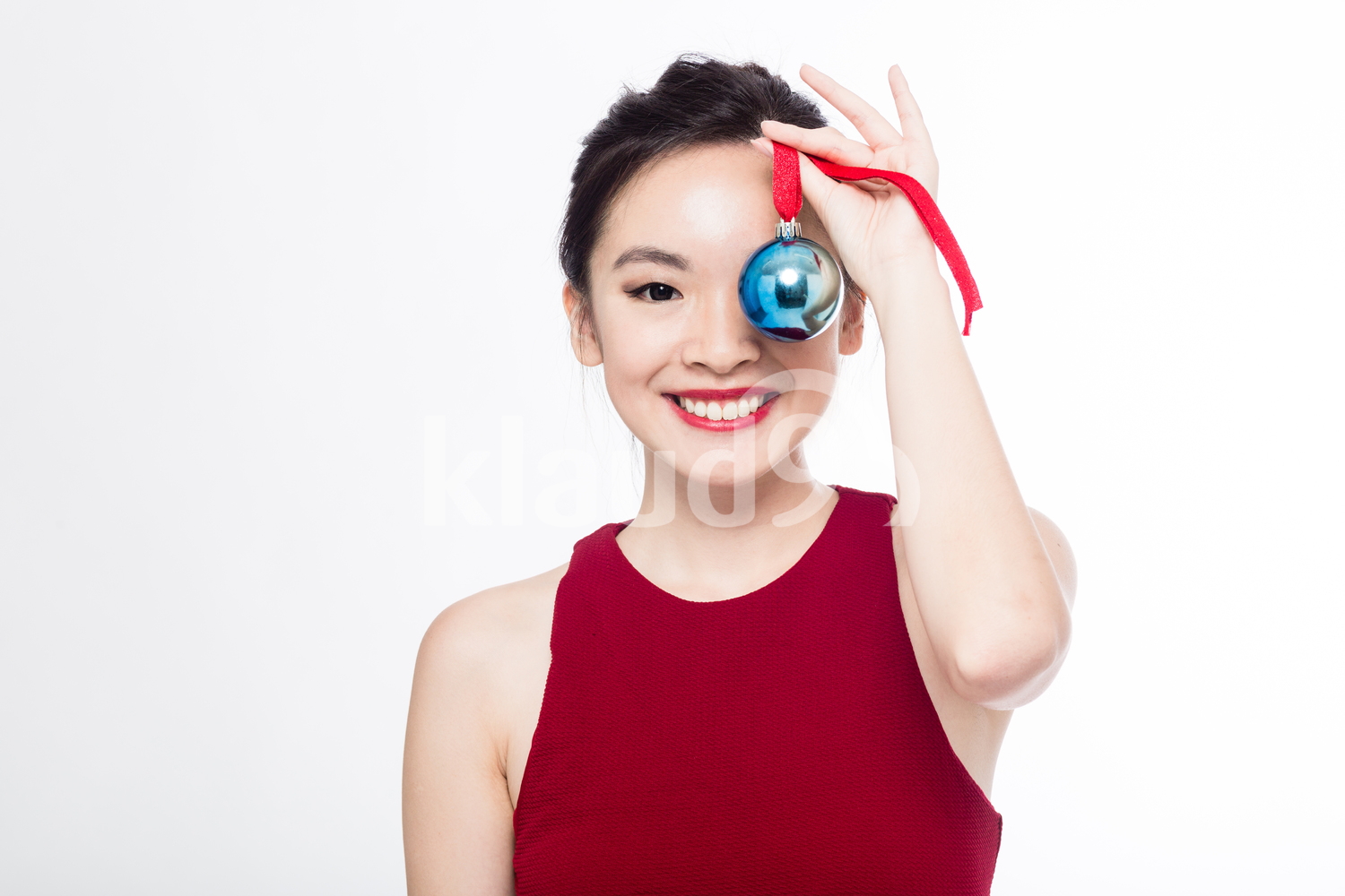 Pan Asian woman with her Christmas ball ornament