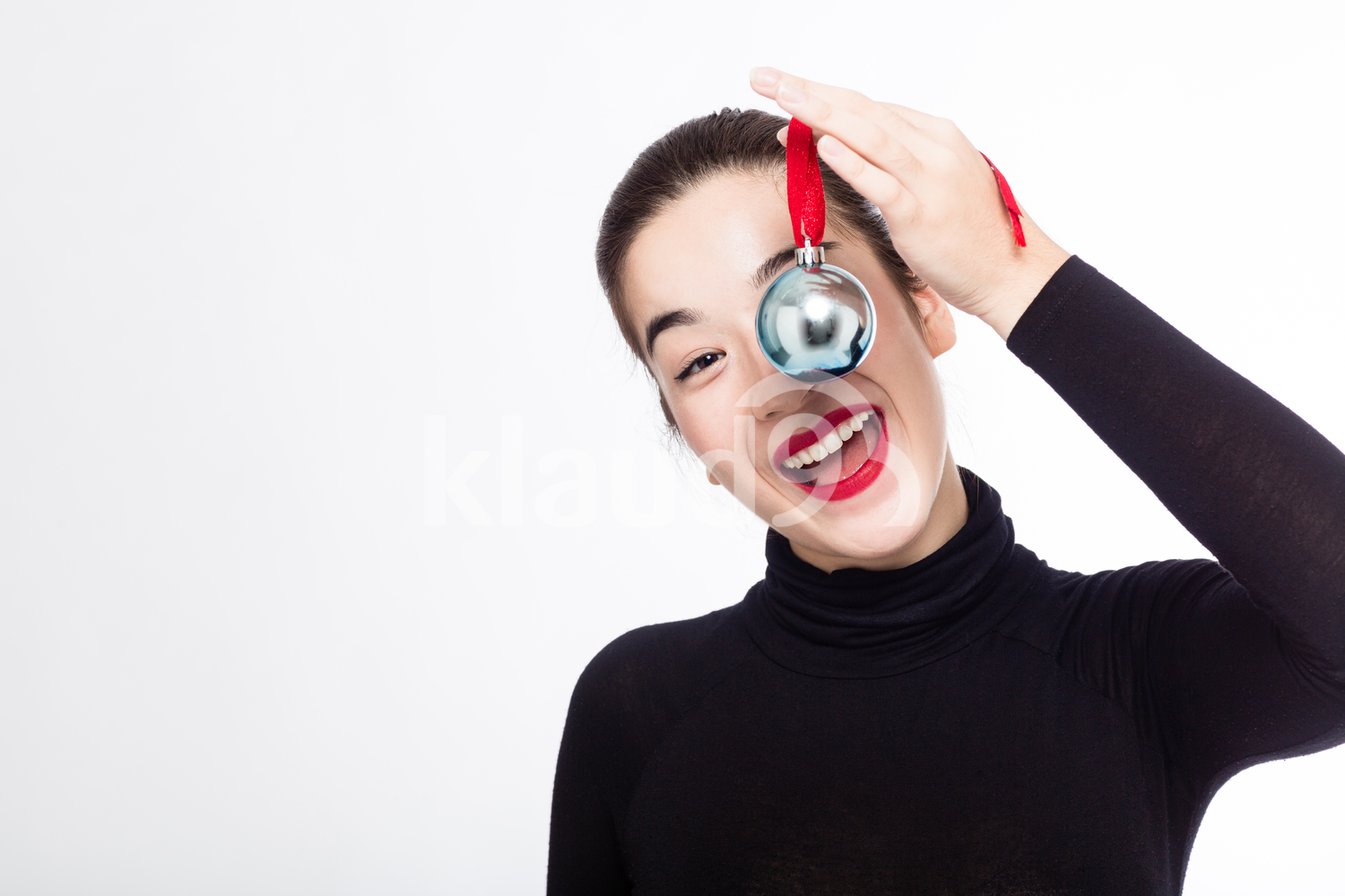 Pretty Woman Smiling Happily with her Christmas Ball Ornament