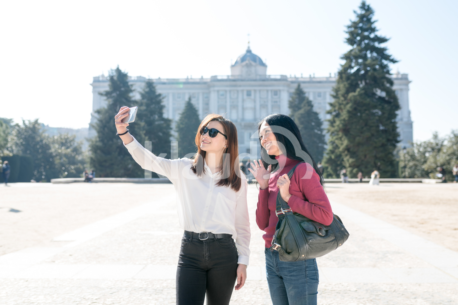 Cheerful Asian women with a Camera Phone