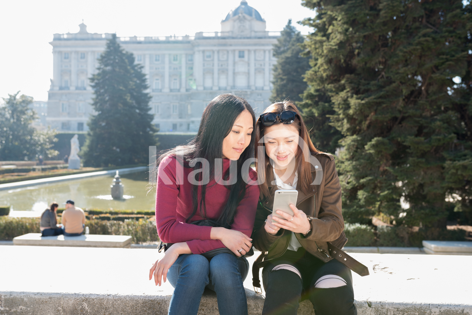 Asian women browsing phone in Madrid