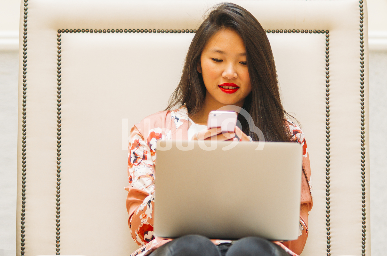 Asian woman texting on her smartphone