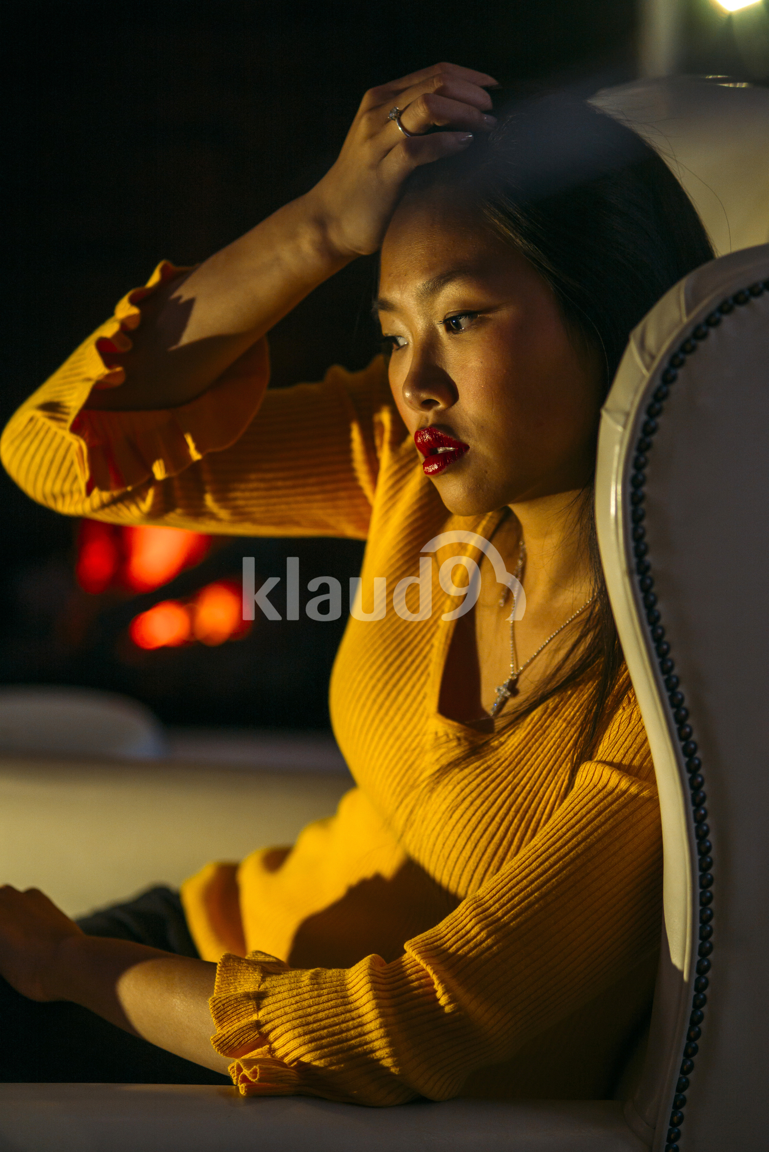 Asian woman sitting on a couch