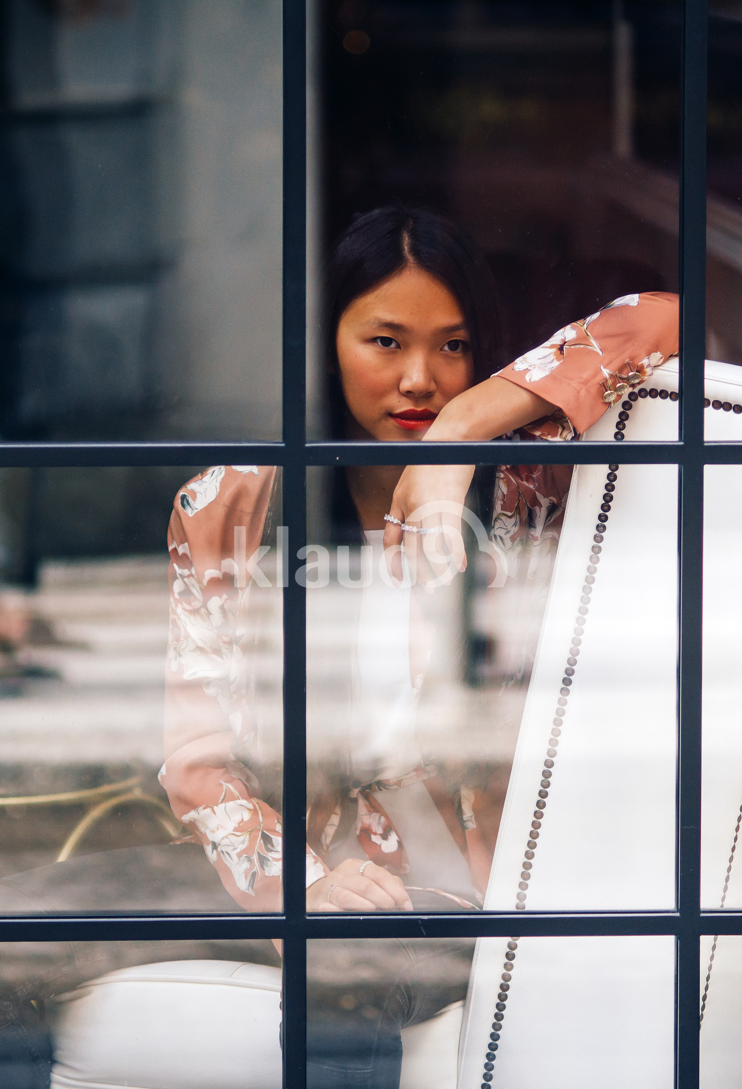 Asian long Hair woman looking through a window 