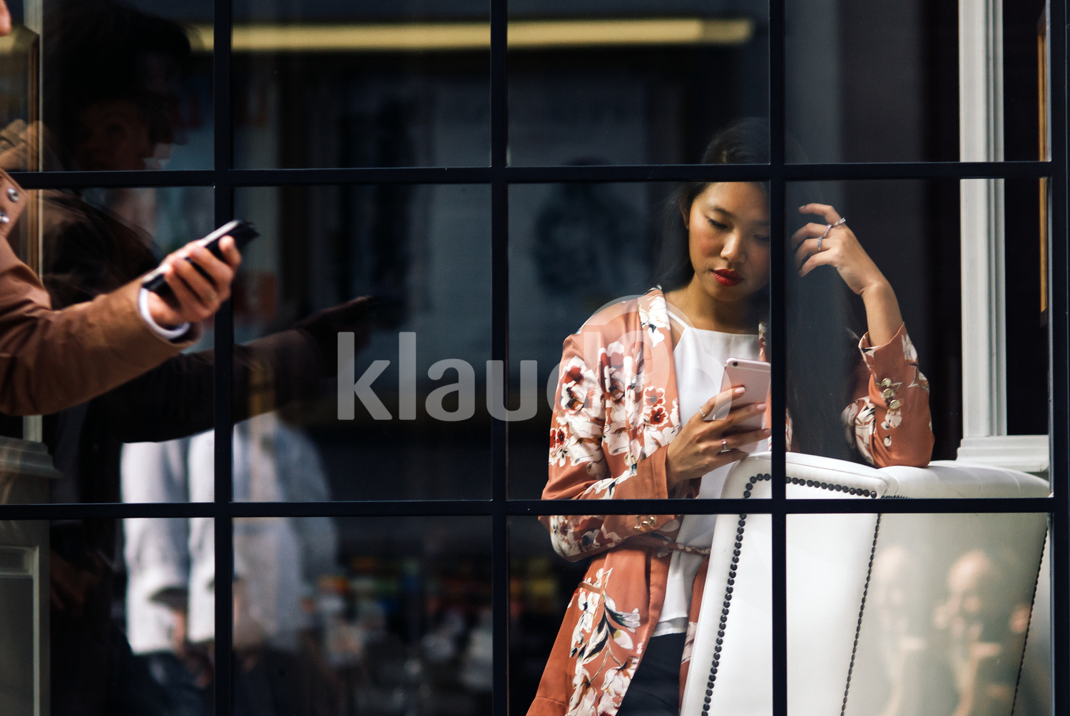 PrettyChinese woman standing and browsing her mobile phone