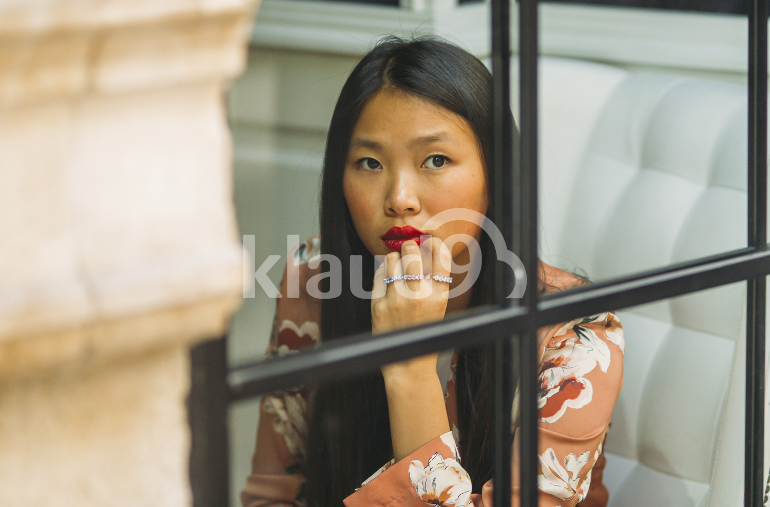 Asian woman looking through the window
