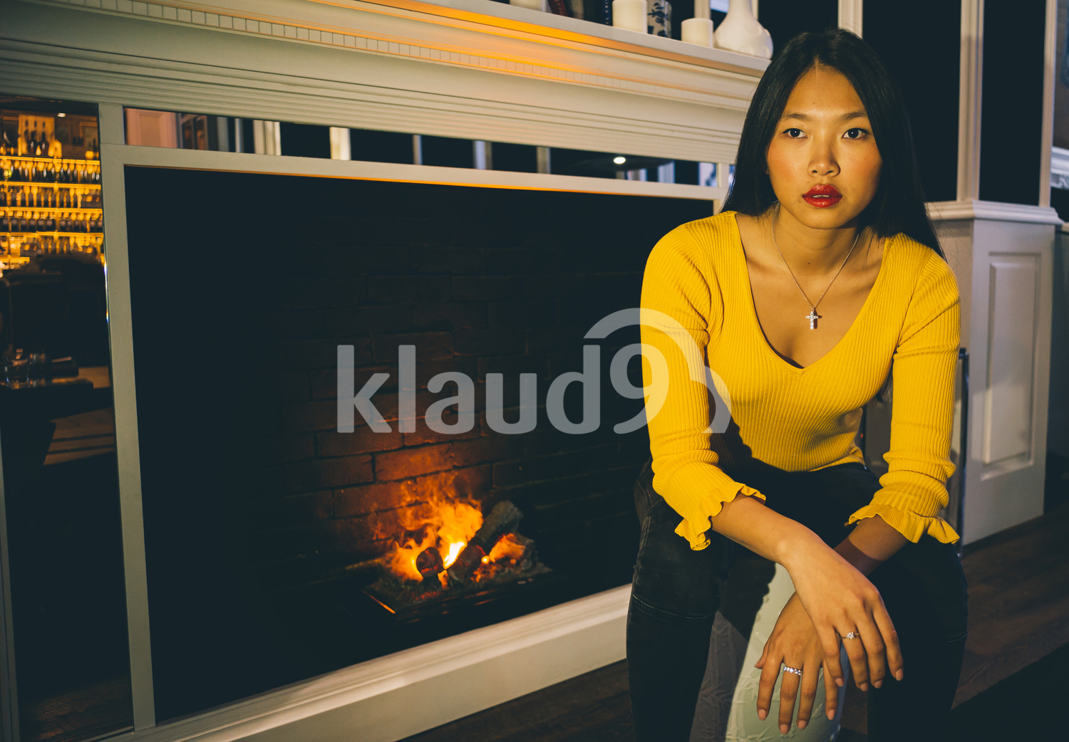 Chinese woman sitting by the fireplace