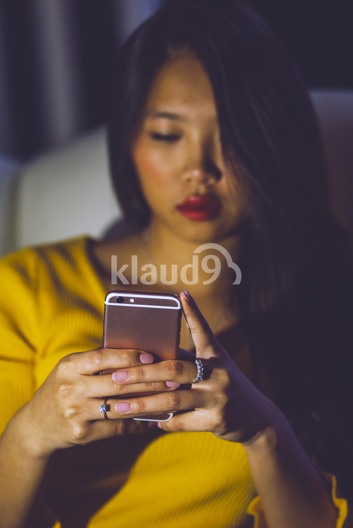 Long Hair Chinese woman browsing her smartphone