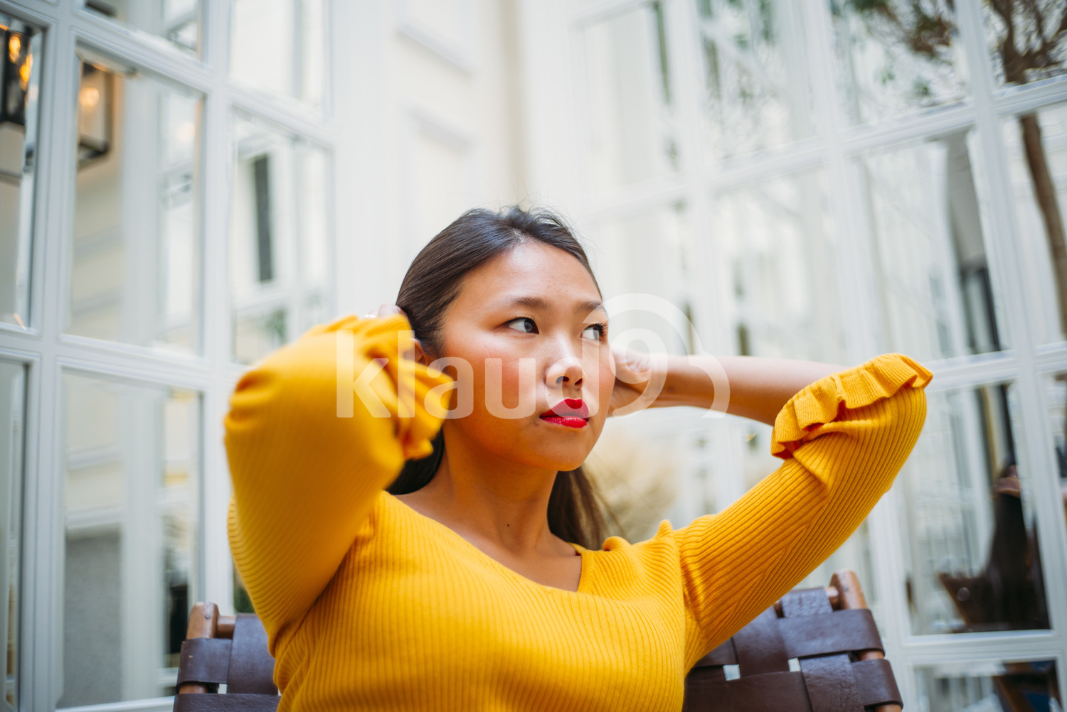 Chinese woman tying her long Hair