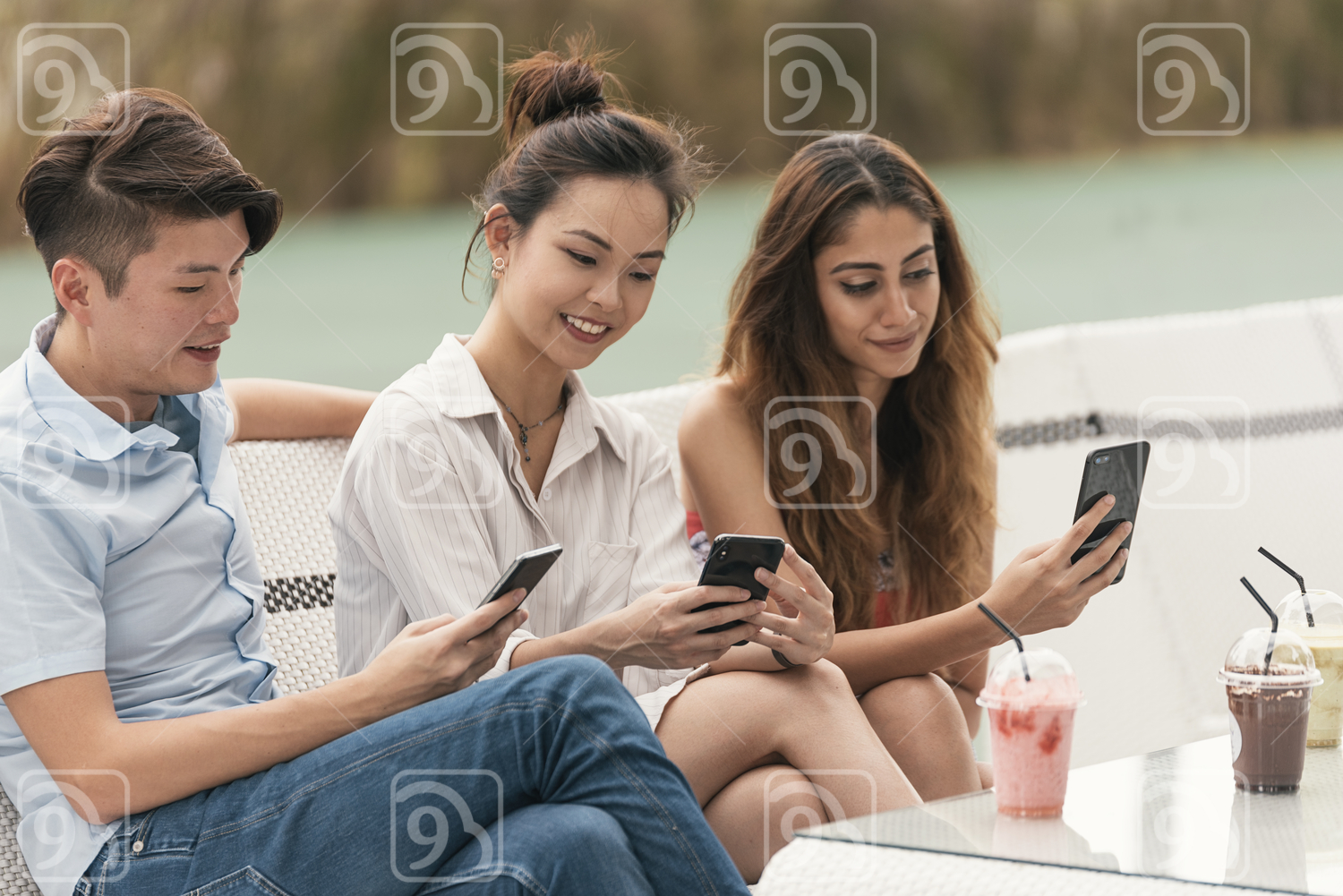 Asian friends browsing their mobile phone 