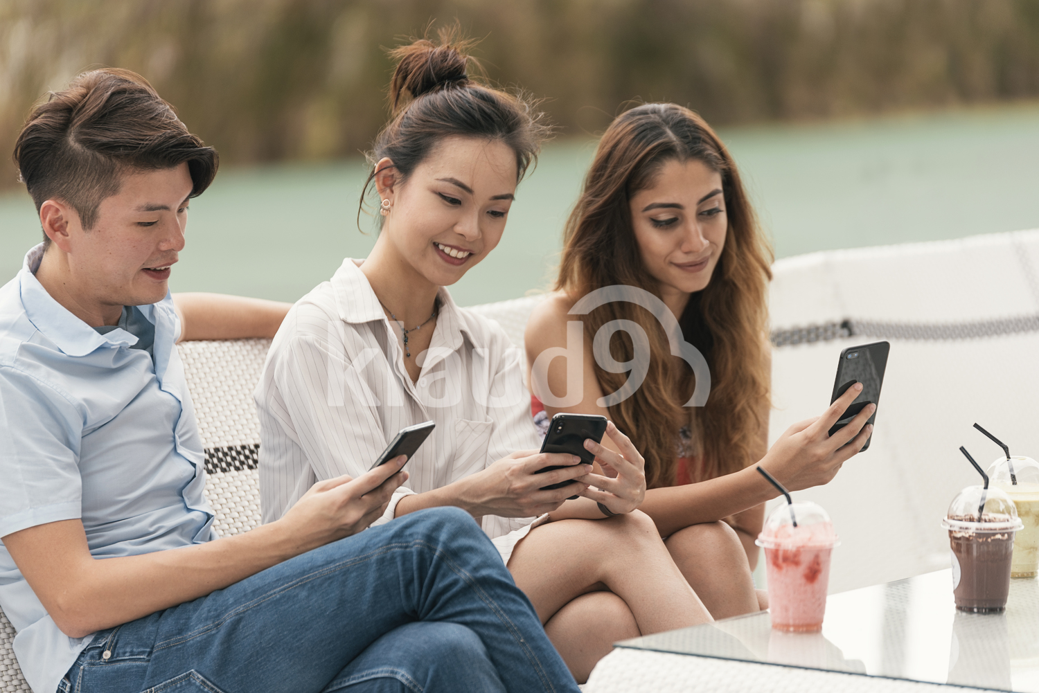 Asian friends browsing their mobile phone