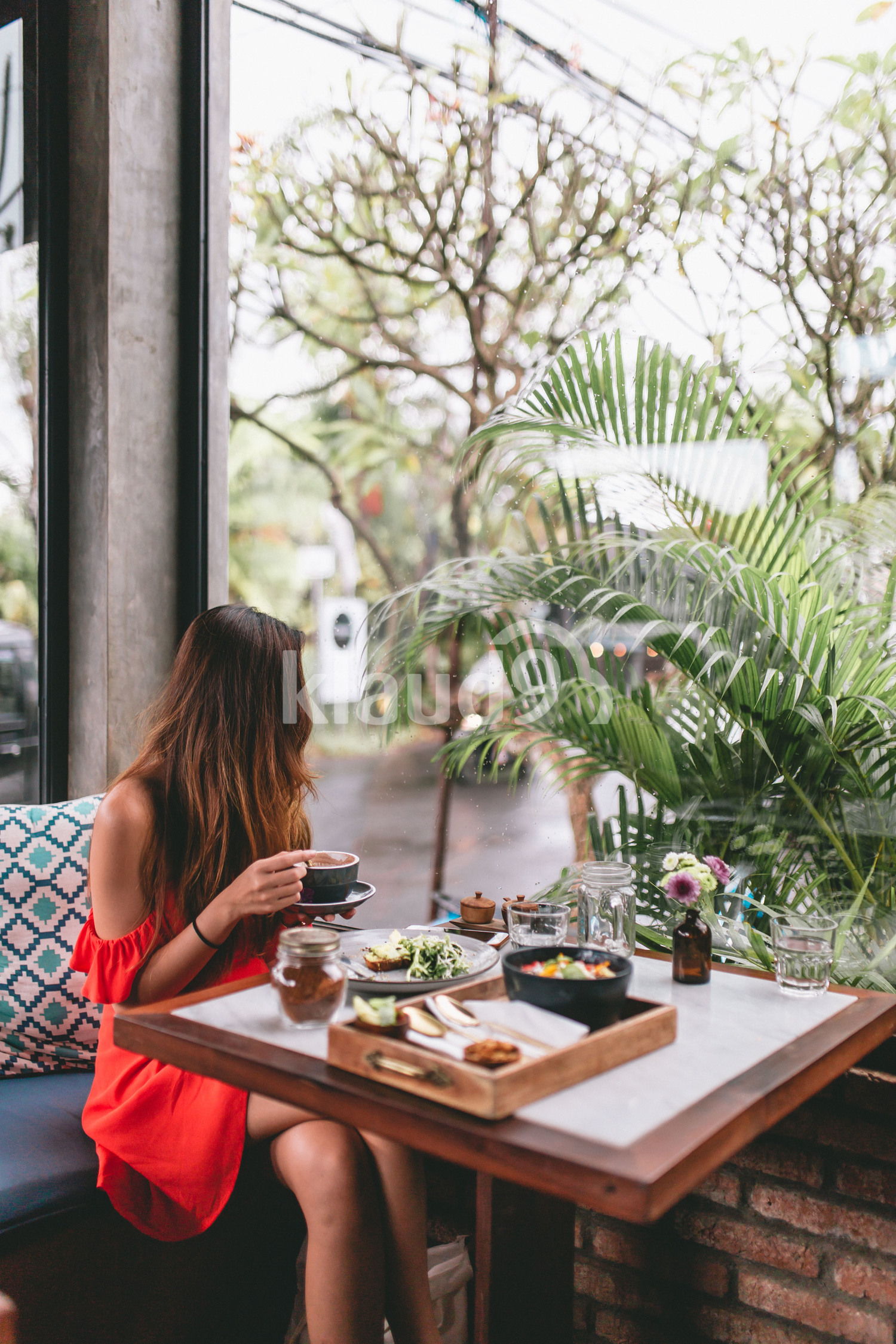 Side View of a long hair woman having coffee
