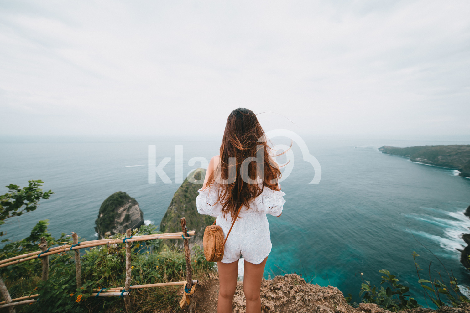Back View of an Asian woman looking at the sea